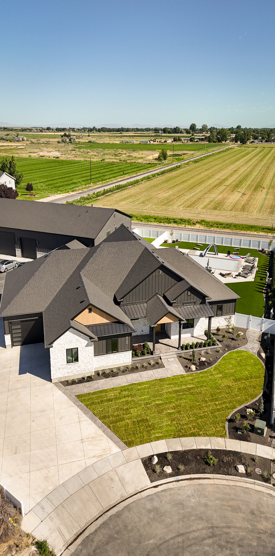 Aerial view of a modern Utah estate with a pool and newly installed landscape
