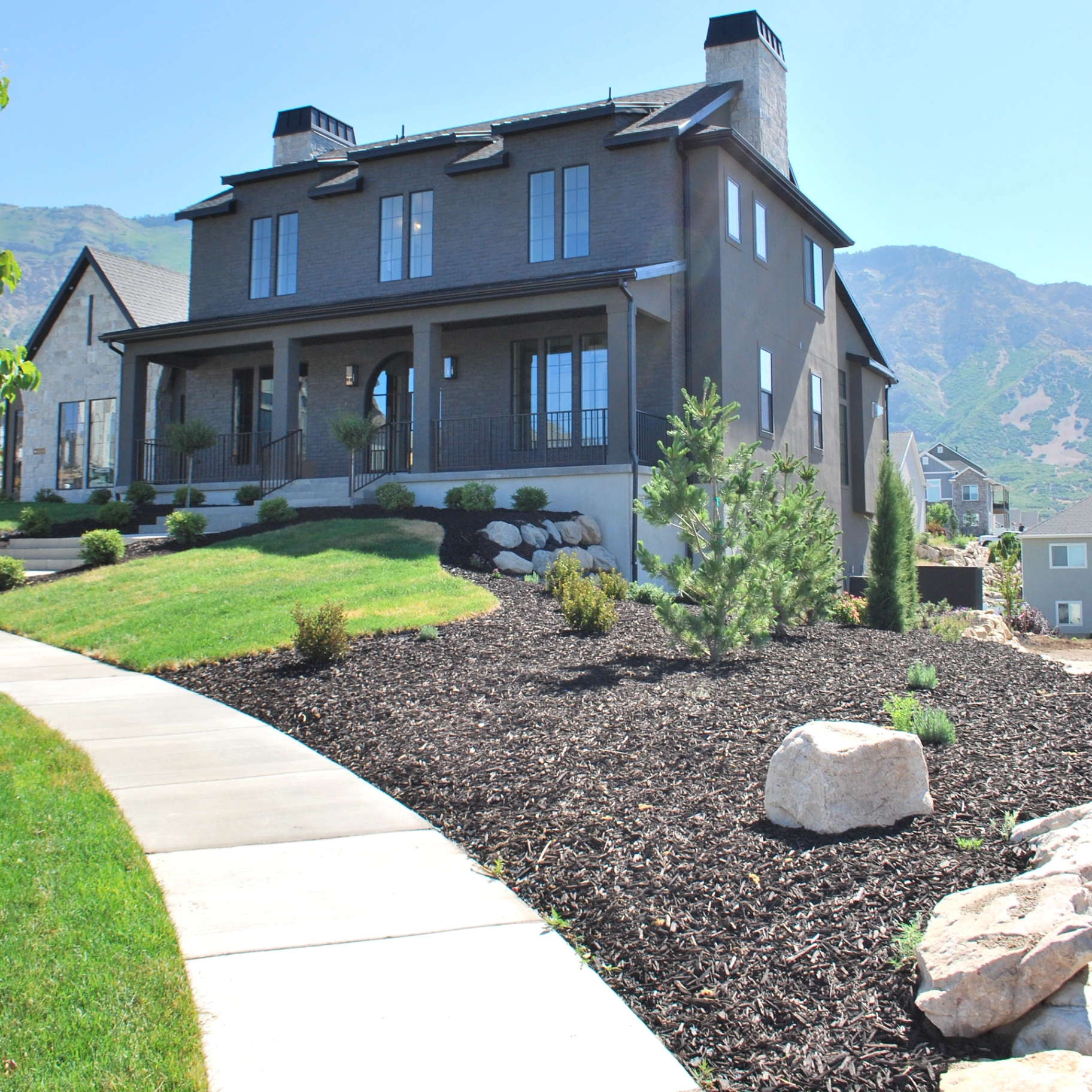 Mountain home elevation with mature landscape